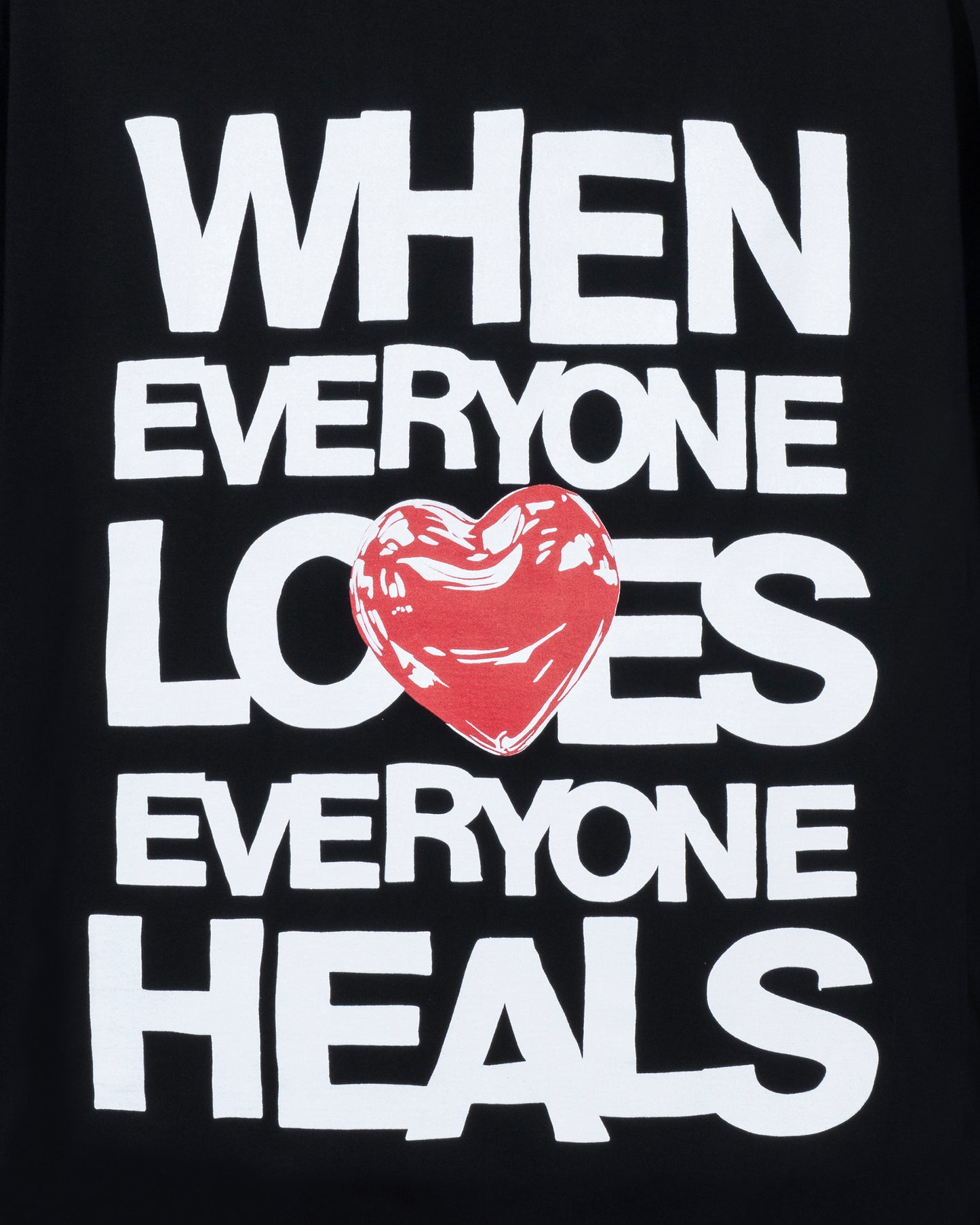Black t-shirt with white text and a red heart graphic on a black background