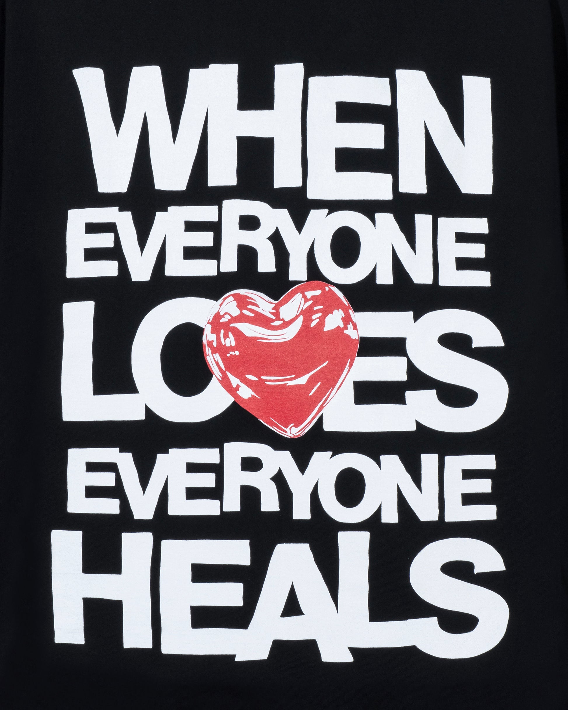 Black t-shirt with white text and a red heart graphic on a black background