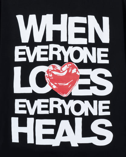 Black t-shirt with white text and a red heart graphic on a black background